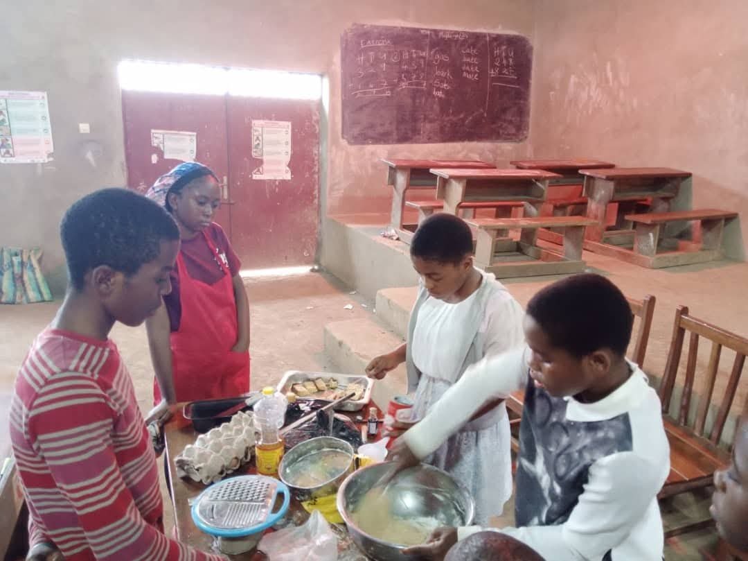 Training Children in Bwitingi community on baking cakes and pastries at the community hall